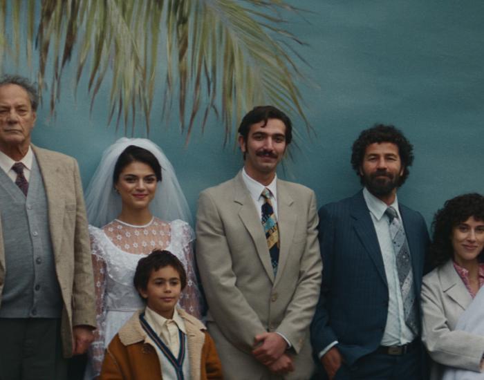 A multigenerational family pose for a portrait photograph